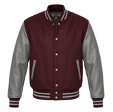 A varsity-style jacket with a maroon body and grey sleeves, featuring gray striped ribbed collar, cuffs, and hem, and silver snap buttons.