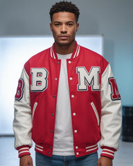 Person wearing a red and white varsity jacket with 'B' and 'M' letters on a neutral background