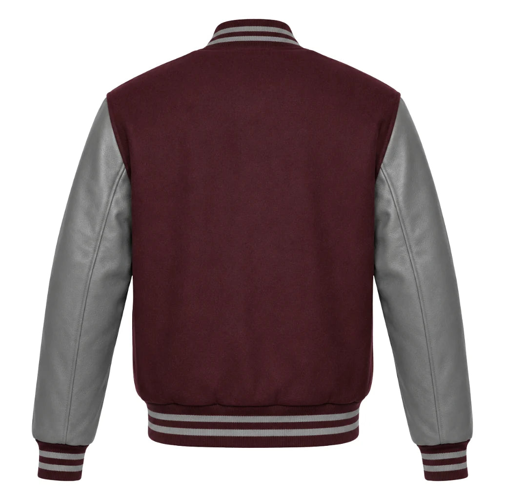 A classic varsity jacket shown from the back, featuring a deep maroon wool body and contrasting light grey leather sleeves, with striped ribbed collar, cuffs, and hem.